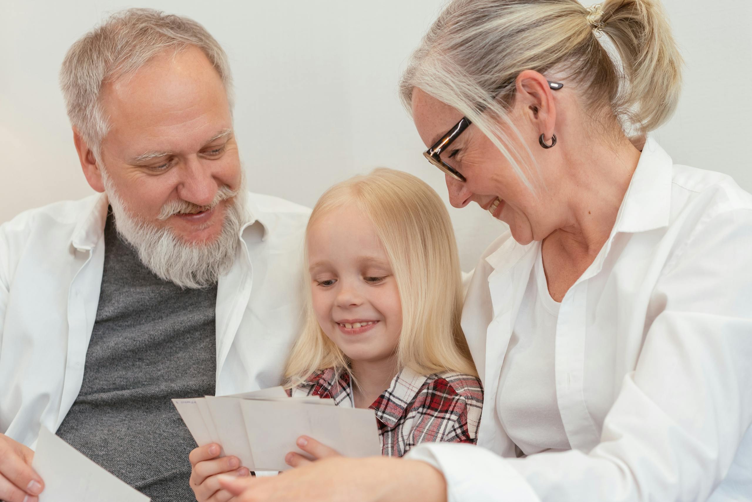 Joyful family gathering, grandparents sharing memories with granddaughter, highlighting love and connection.